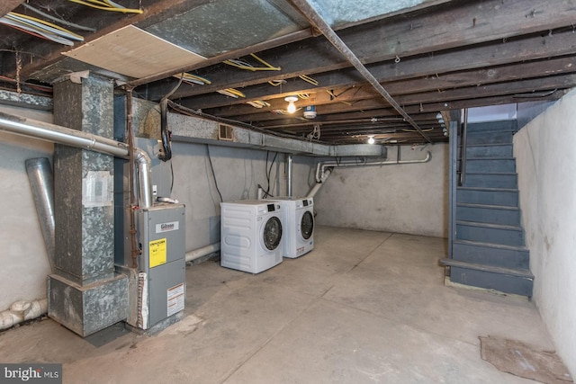 basement featuring washer and clothes dryer and heating unit