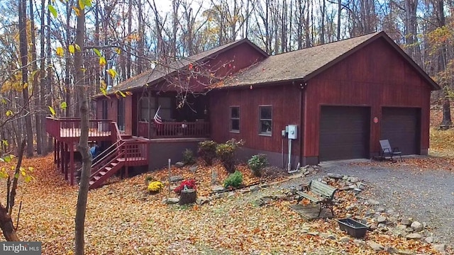 view of property exterior with a garage and a wooden deck