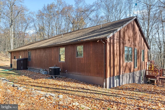 view of property exterior featuring central air condition unit and a wooden deck