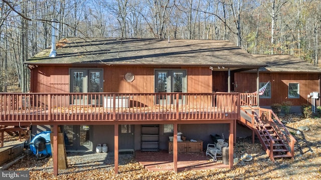 back of house featuring a wooden deck and a patio area