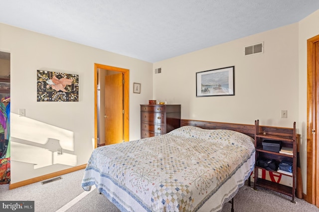 carpeted bedroom with a textured ceiling