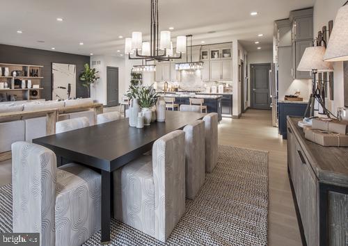 dining area with an inviting chandelier and light wood-type flooring