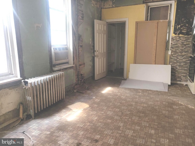 unfurnished room featuring radiator