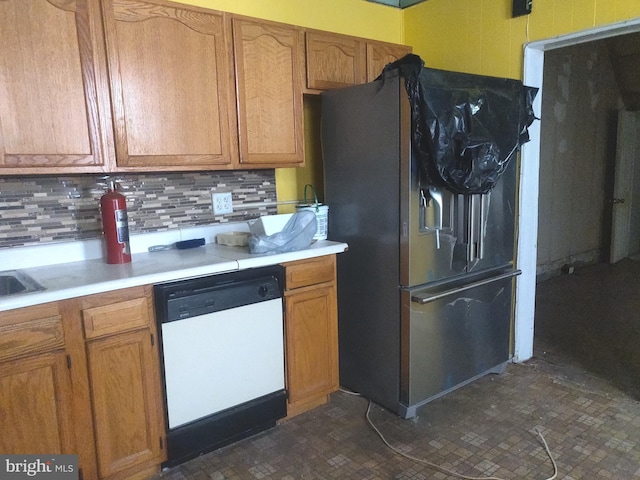 kitchen with tasteful backsplash, black refrigerator with ice dispenser, and dishwasher