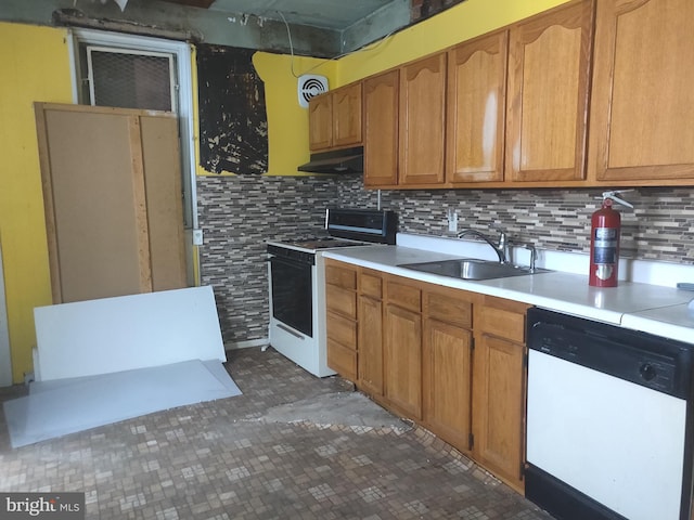 kitchen with sink, decorative backsplash, and white appliances