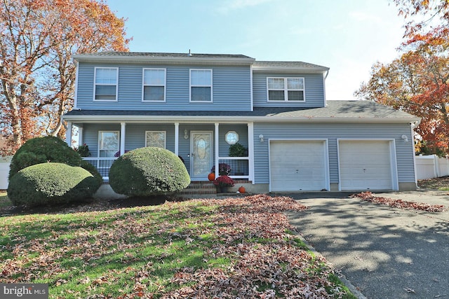 view of property featuring a garage and a porch