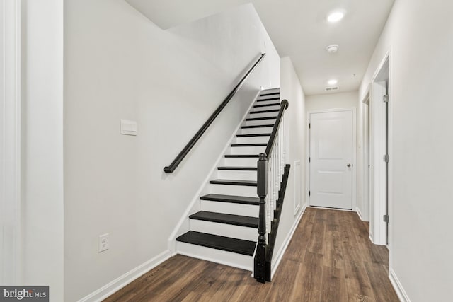 stairs featuring hardwood / wood-style floors