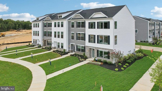 view of property featuring a front lawn