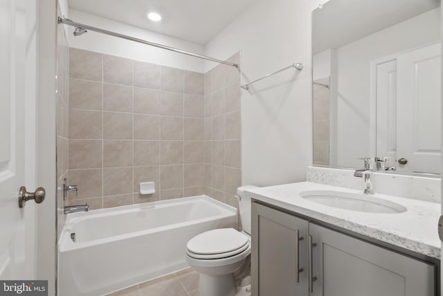 full bathroom featuring vanity, toilet, tile patterned flooring, and tiled shower / bath