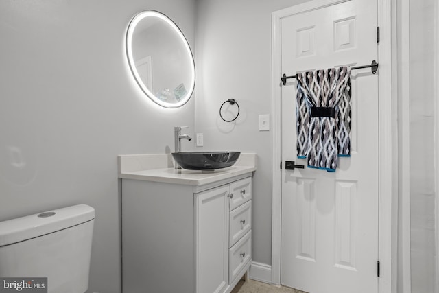 bathroom featuring vanity and toilet