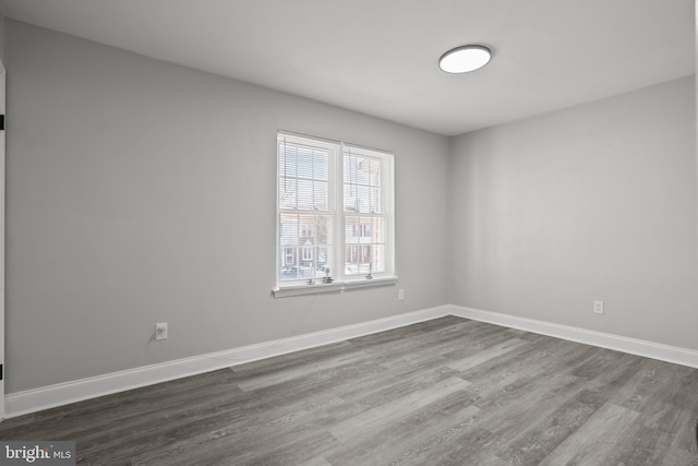 spare room with wood-type flooring