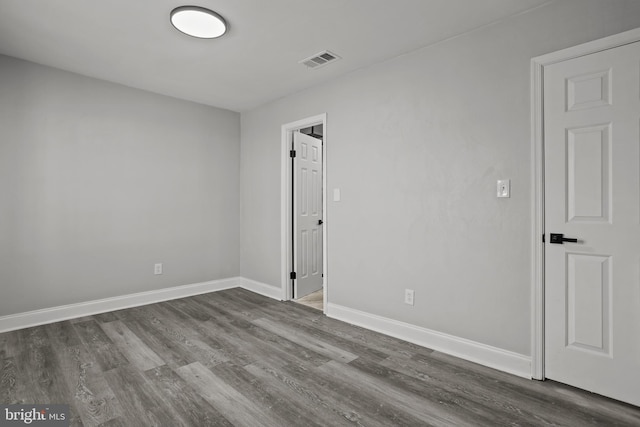 unfurnished room featuring dark wood-type flooring