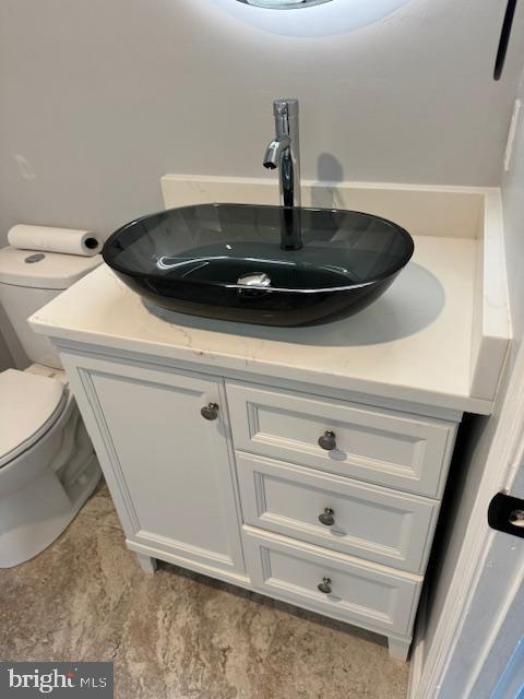 bathroom with vanity and toilet