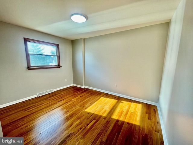 spare room with hardwood / wood-style floors