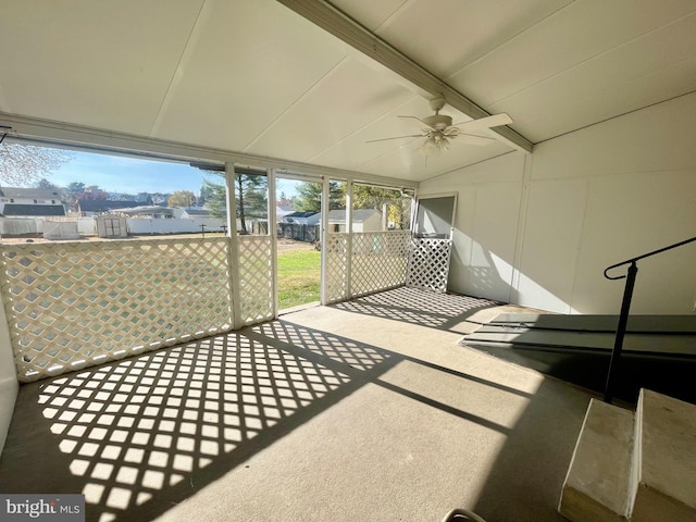 sunroom / solarium with ceiling fan, lofted ceiling with beams, and a wealth of natural light