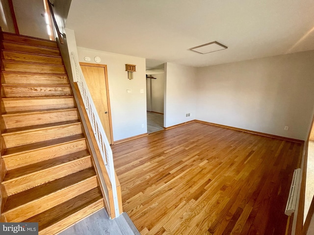 stairs featuring wood-type flooring