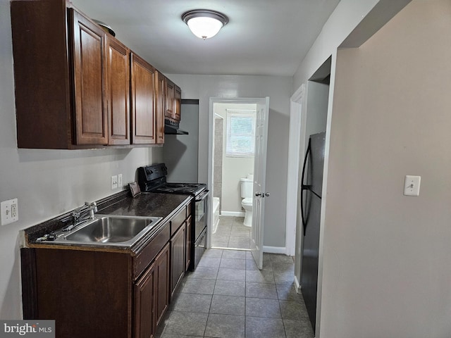 kitchen featuring dark tile patterned flooring, black refrigerator, dark brown cabinets, sink, and electric stove