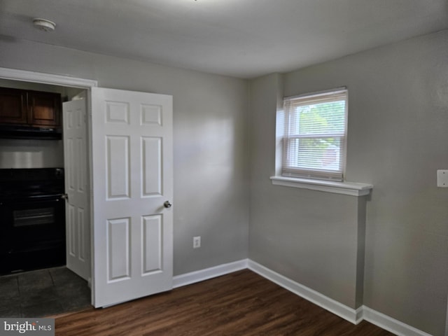 unfurnished bedroom with dark hardwood / wood-style floors