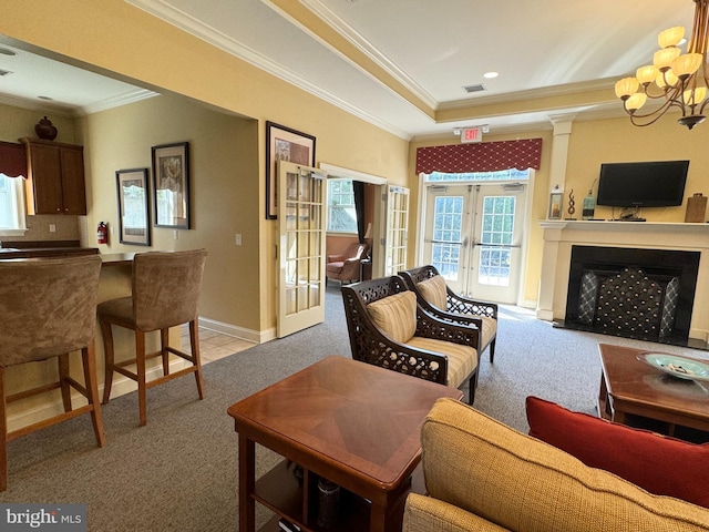 carpeted living room with french doors, an inviting chandelier, and ornamental molding