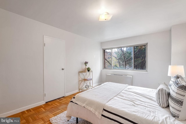 bedroom with light parquet flooring