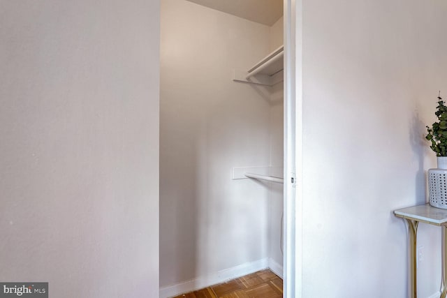 spacious closet with light parquet flooring