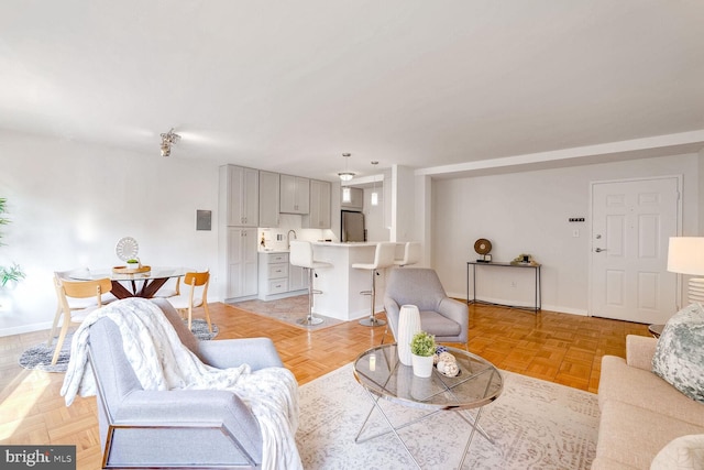 living room featuring sink and light parquet flooring