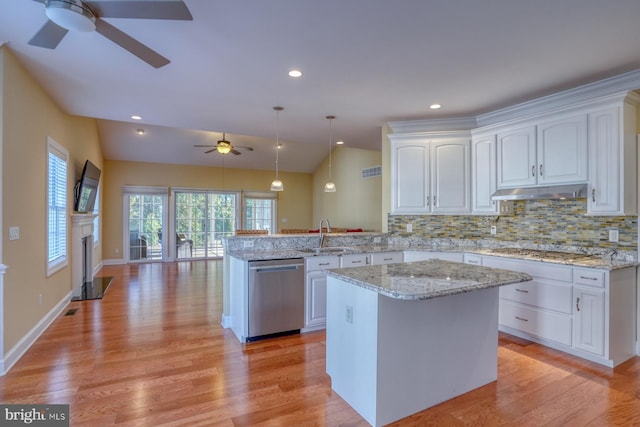 kitchen featuring dishwasher, kitchen peninsula, decorative light fixtures, and light hardwood / wood-style floors