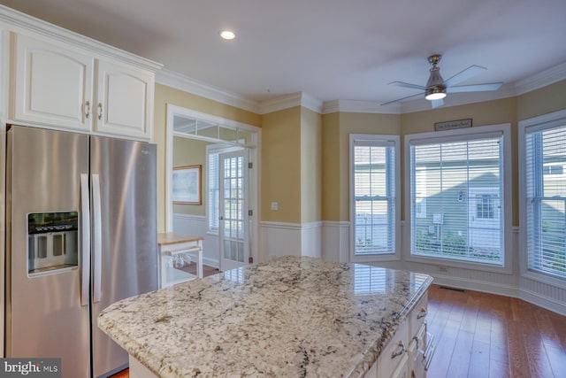 kitchen featuring stainless steel fridge, white cabinetry, dark wood-type flooring, and a healthy amount of sunlight