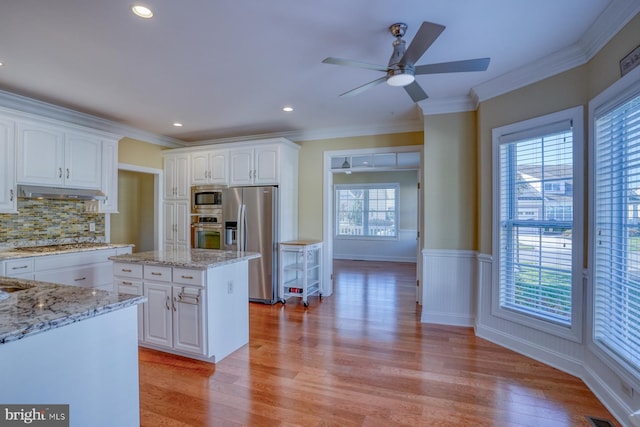 kitchen featuring appliances with stainless steel finishes, white cabinetry, and light wood-type flooring