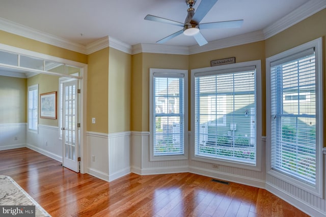 unfurnished room with ceiling fan, crown molding, and hardwood / wood-style floors