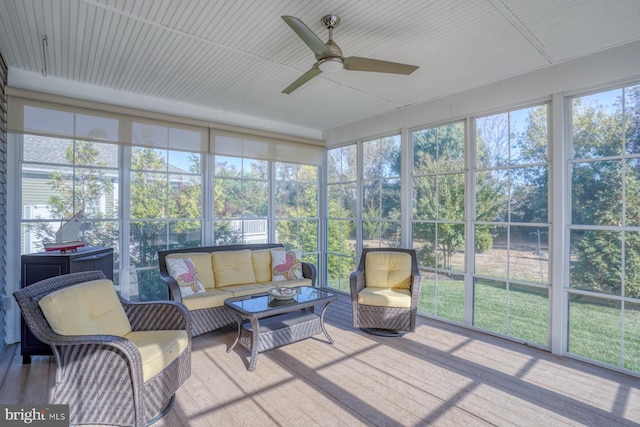 sunroom / solarium featuring ceiling fan