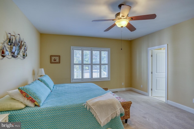 bedroom featuring light colored carpet and ceiling fan