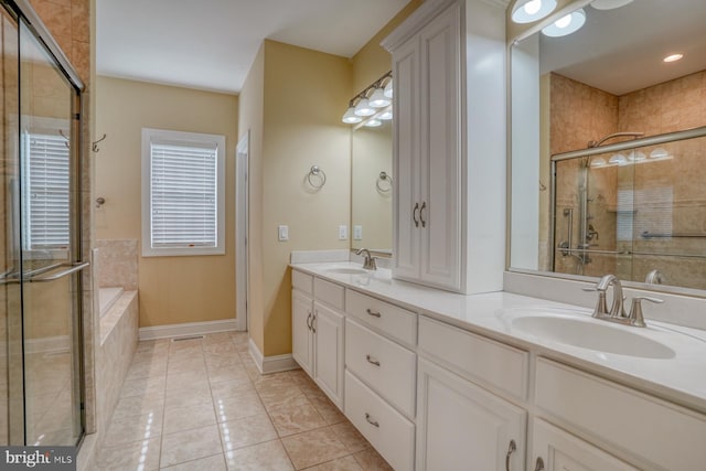 bathroom featuring vanity, plus walk in shower, and tile patterned floors