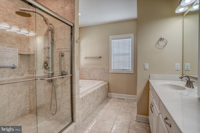 bathroom featuring vanity, shower with separate bathtub, and tile patterned flooring