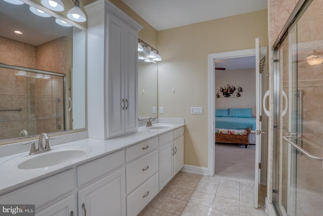 bathroom featuring vanity, tile patterned floors, and a shower with shower door