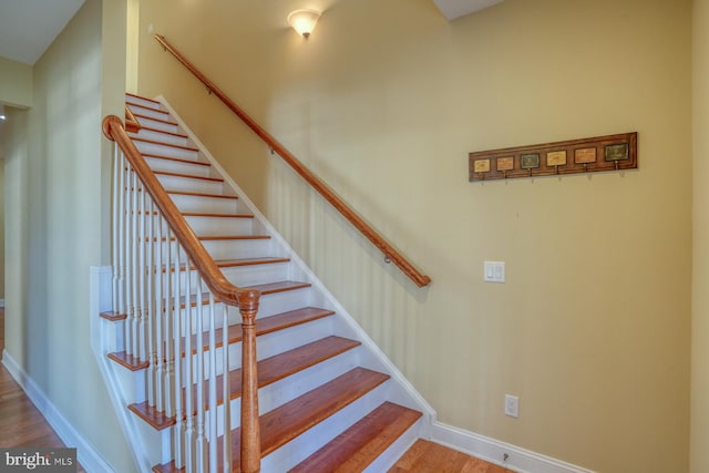 stairs with wood-type flooring