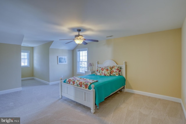 bedroom featuring ceiling fan, light carpet, lofted ceiling, and multiple windows