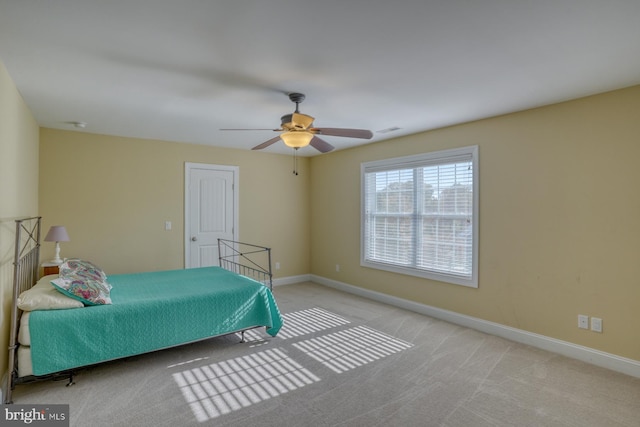 unfurnished bedroom featuring light carpet and ceiling fan