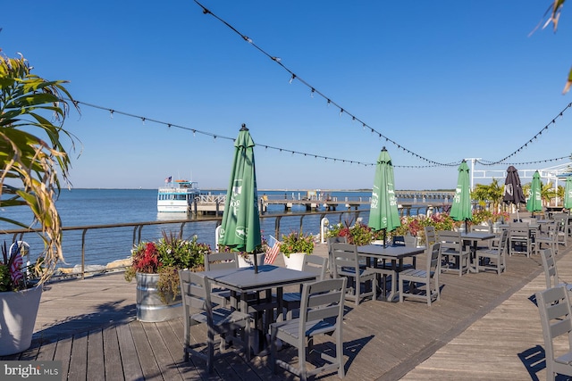 wooden terrace featuring a water view