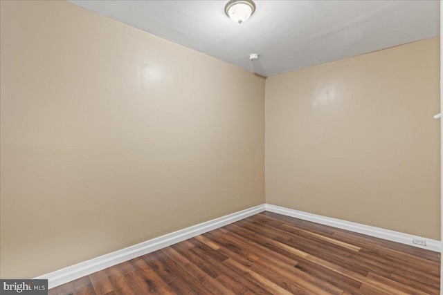 spare room with dark hardwood / wood-style flooring