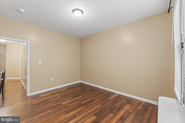 unfurnished room featuring dark hardwood / wood-style flooring