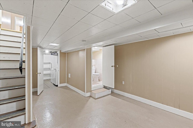 basement featuring washer / dryer and a drop ceiling