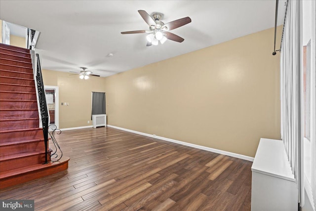 unfurnished living room with radiator, ceiling fan, and dark hardwood / wood-style floors