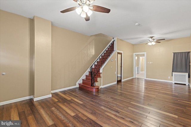 interior space with dark hardwood / wood-style floors, radiator heating unit, and ceiling fan