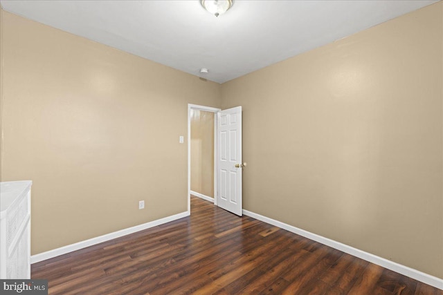 unfurnished room featuring dark hardwood / wood-style flooring