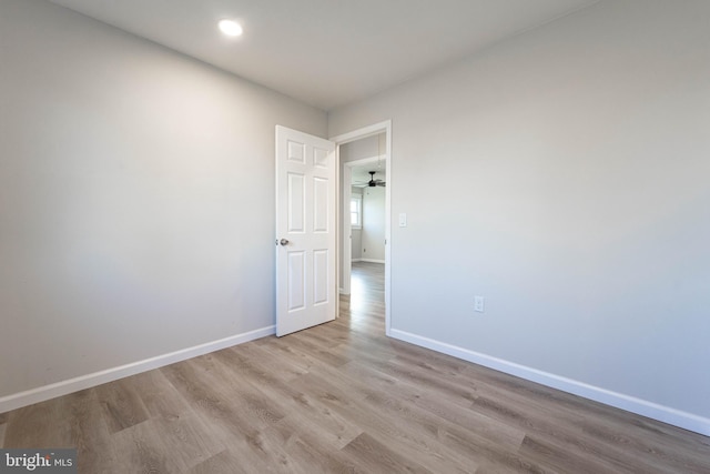 unfurnished room featuring light hardwood / wood-style floors and ceiling fan