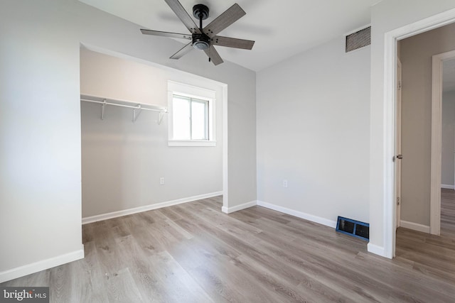 unfurnished bedroom featuring light hardwood / wood-style flooring, a closet, and ceiling fan