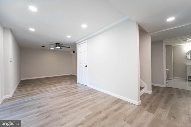 empty room with light hardwood / wood-style floors and ceiling fan