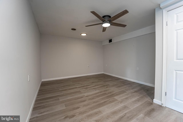 spare room featuring ceiling fan and light wood-type flooring