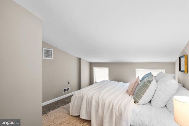 bedroom with lofted ceiling and carpet floors